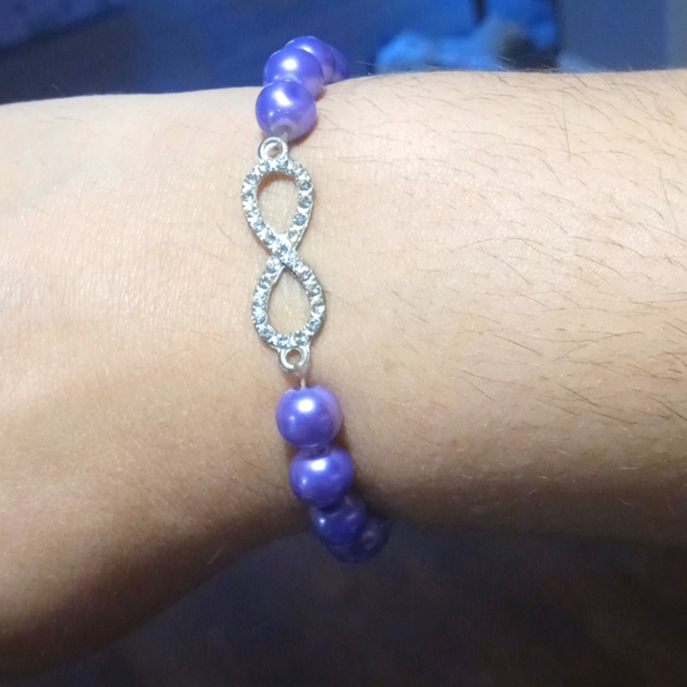 Purple beaded bracelet w/ infinity symbol